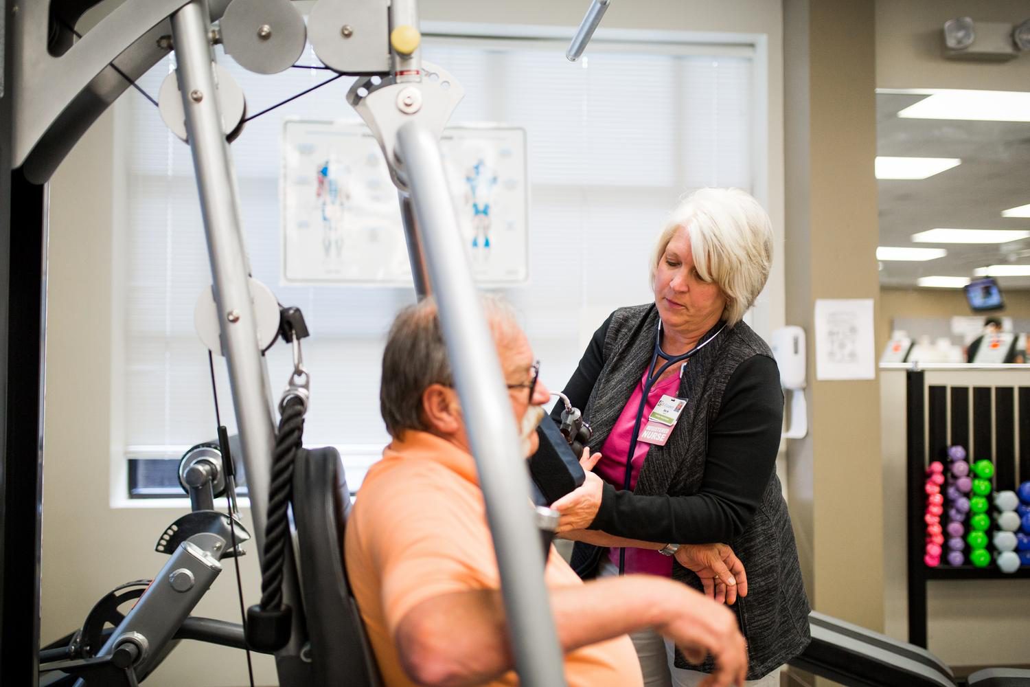 Nurse in cardiac rehab checking blood pressure on a patient