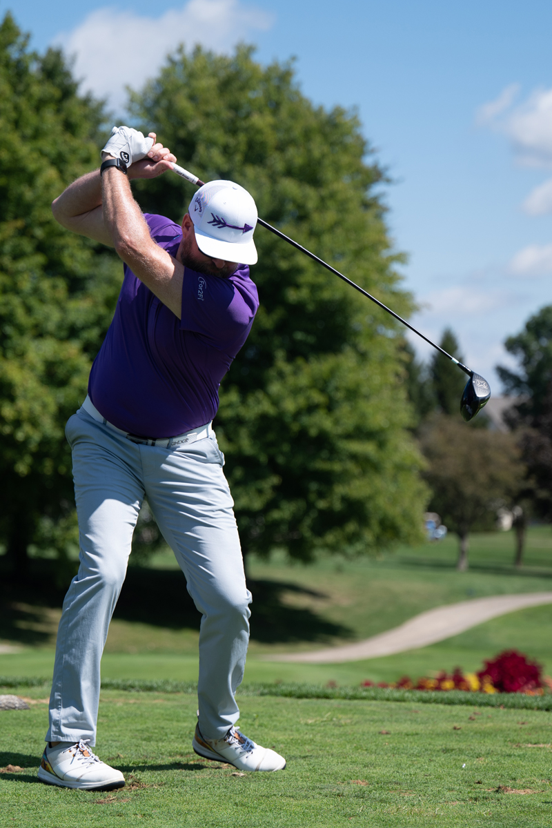 Man swings at a Golf Club